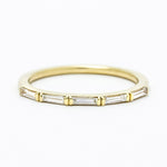 A modern minimal baguette diamond wedding band