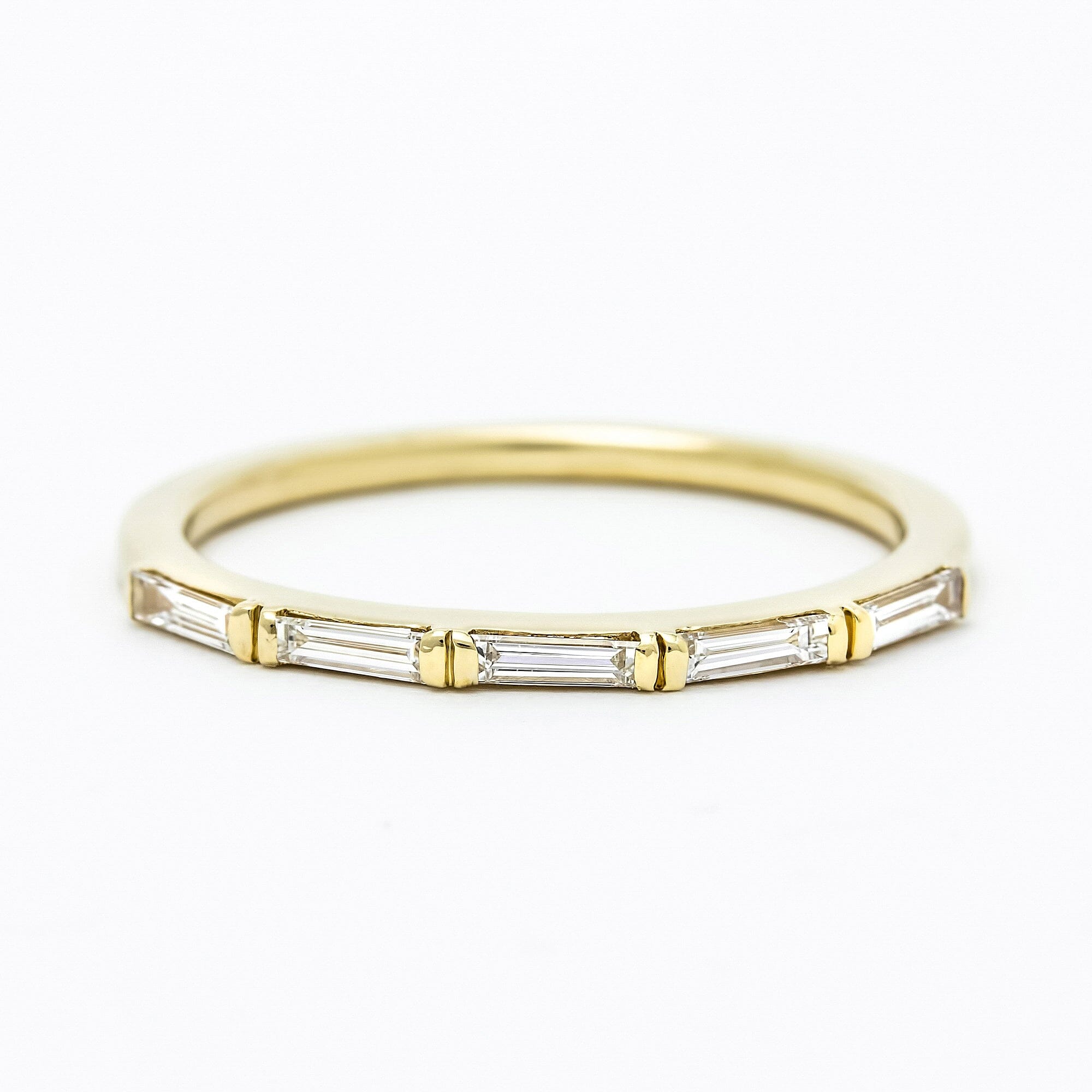A modern minimal baguette diamond wedding band